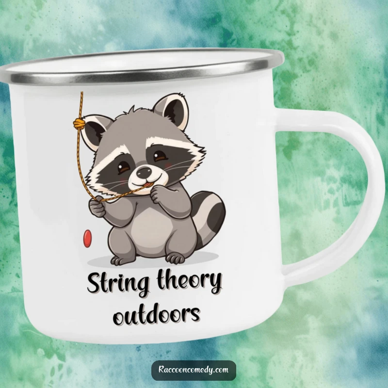 Funny kawaii raccoon camping mug, playfully batting at a dangling string, bringing joy to outdoor moments.