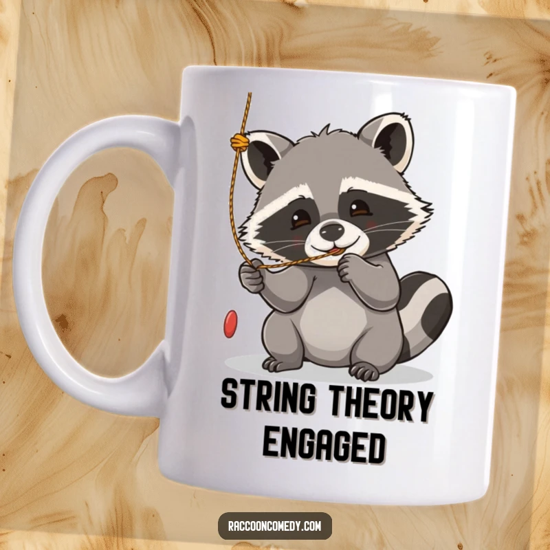 Funny kawaii raccoon mug, eyes wide with playful focus, batting at a dangling string with delight.