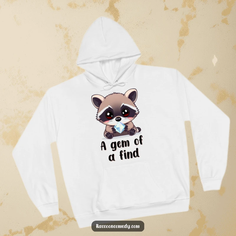 Funny curious raccoon gem hoodie featuring a raccoon with wide, bright eyes examining a sparkling gem, designed for warmth and a sense of wonder.