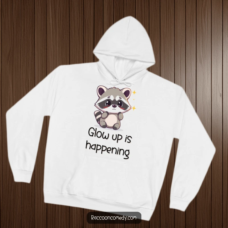 Funny kawaii raccoon looking surprised by a shimmering light, depicted on a soft, cozy hoodie for magical comfort.