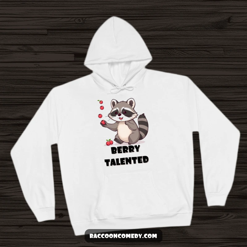 Funny hoodie showing a playful raccoon juggling colorful berries with its paws, providing warmth and a touch of lighthearted skill.