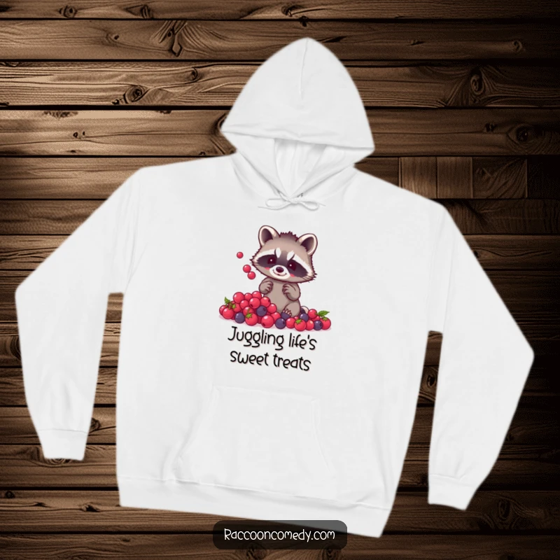 Funny raccoon berry juggling hoodie featuring a small raccoon with tiny paws expertly juggling a pile of shiny berries, designed for warmth and humor.