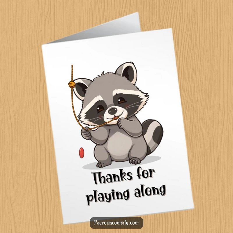 Funny Free Printable Thank You Card: Kawaii raccoon gleefully batting at a string, sending a playful thank you note.