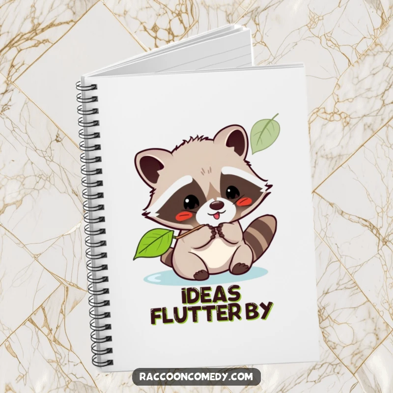 Funny kawaii raccoon playfully batting at a leaf on the cover of a lined notebook for jotting down happy thoughts.