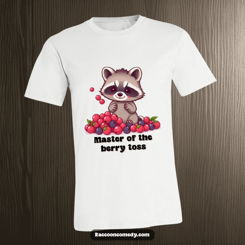 Funny raccoon t-shirt graphic of a small raccoon with tiny paws skillfully juggling a pile of shiny berries, radiating playful energy.