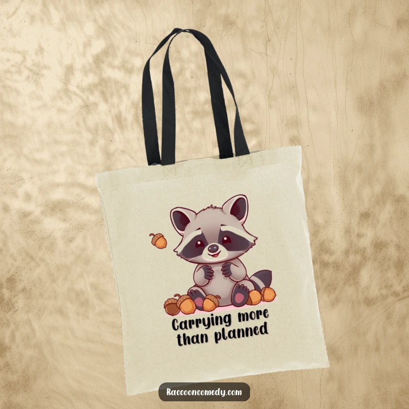 Funny kawaii raccoon with oversized paws hilariously attempting to juggle acorns, printed on a durable tote bag for everyday use.