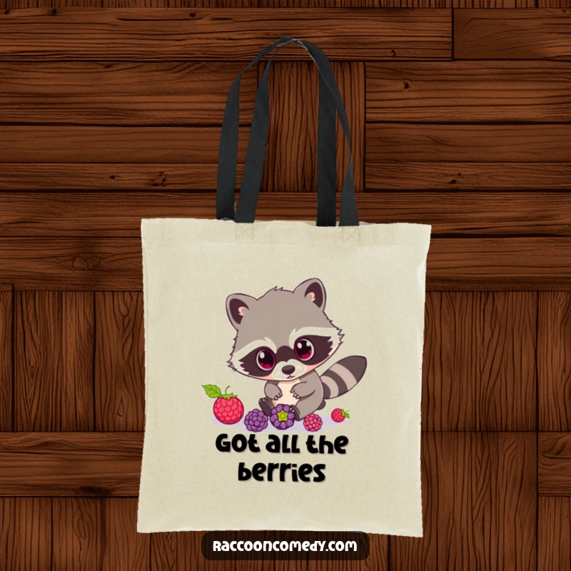 Funny Raccoon Tote Bag: This tote bag displays a cute raccoon character with exaggerated wide eyes, comically chasing rolling berries.